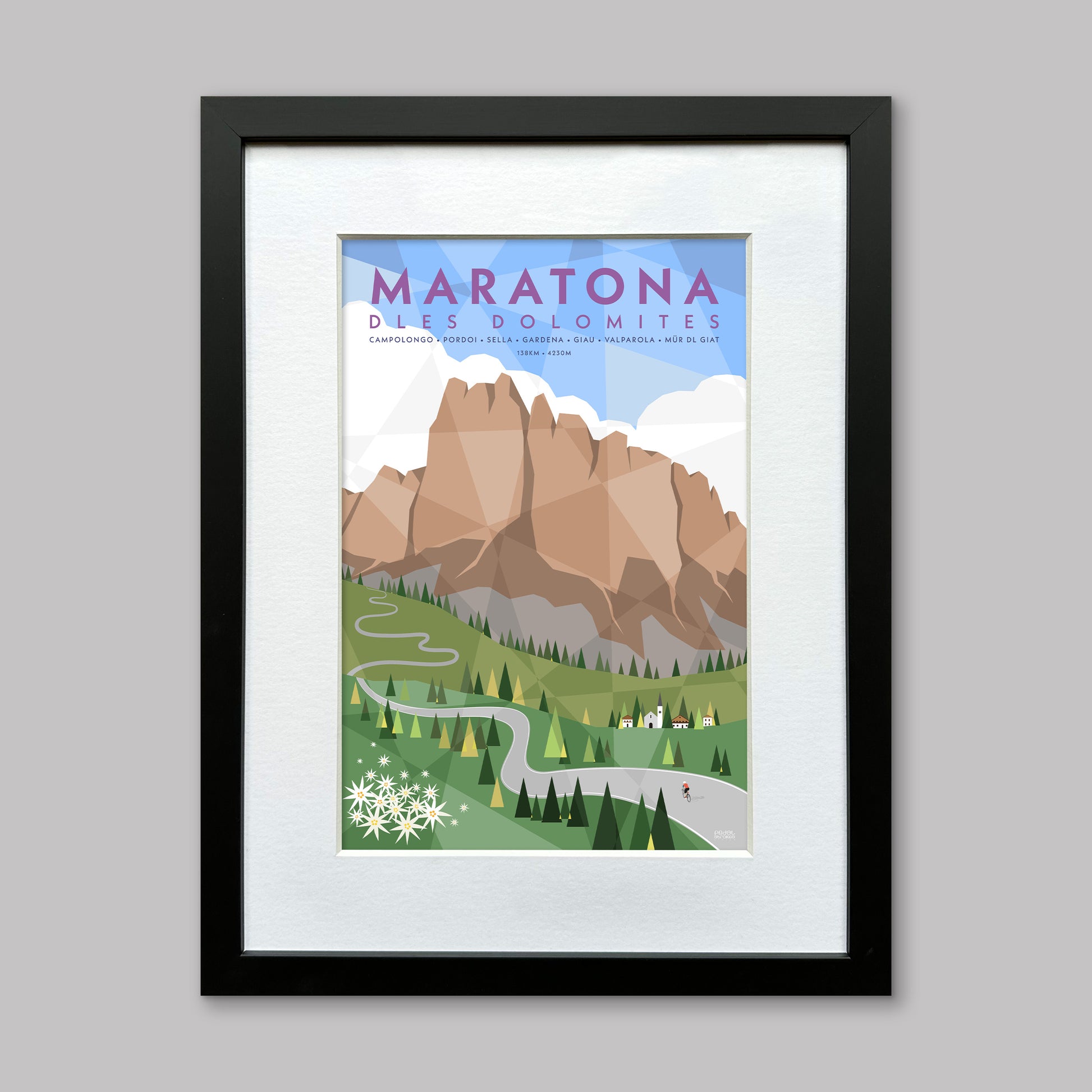 Framed and mounted poster art print of a mountain landscape with 'Maratona Dles Dolomites' text on an illiustration of the dolomites with trees and a cyclist.