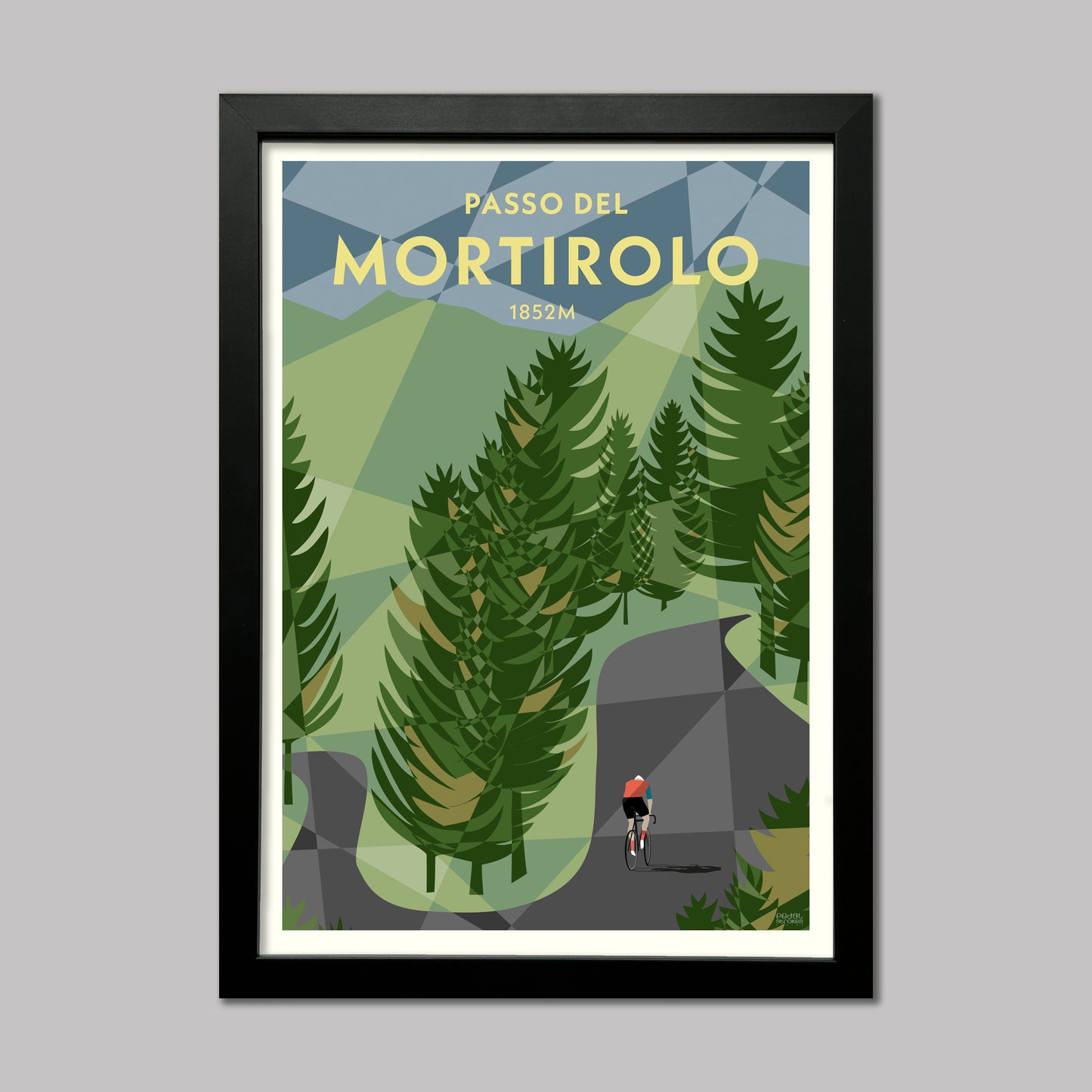Print of a cyclist through the trees on the Mortirolo climb in the Italian Alps. Presented in a black frame.