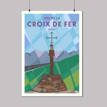 Print of a cyclist riding past the Iron Cross at the top of the Col de la Croix de Fer in the French Alps
