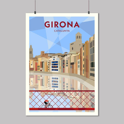 Print of a cyclist crossing the red iron bridge in Girona, Spain over the Onyar River, with the colourful houses of the old city reflected in the water below. 